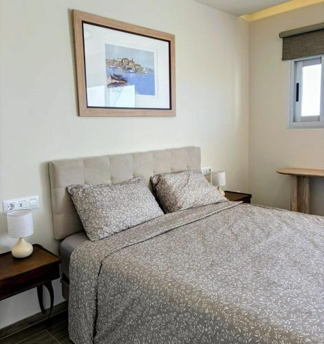 a bedroom with a bed and a picture on the wall at Sanmarcos in Playa Paraiso