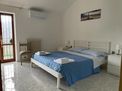 a bedroom with a bed with towels on it at A 2 Colli dal Mare in Varazze