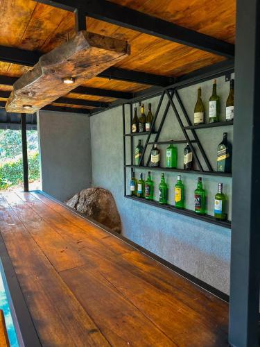a bar with bottles of alcohol on the wall at Alpine Heights in Kumburuteniwela