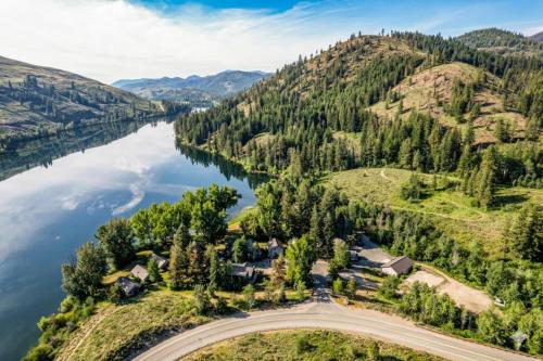 an aerial view of a house on a hill next to a lake at Sun Mountain Lodge in Winthrop