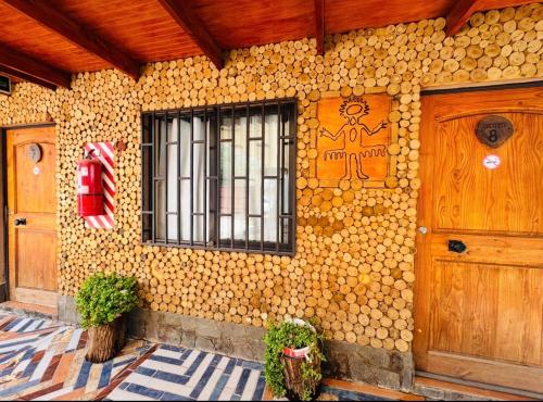 a building with two doors and a fire extinguisher at Hostal El Amigo Lucho in San Pedro de Atacama