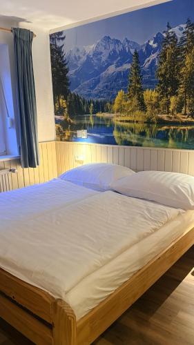a bedroom with a large bed with a large window at AH Carinthia Mallnitz - Carinthia Appartements in Mallnitz