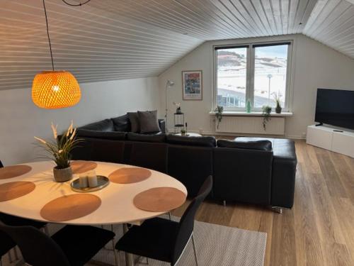 a living room with a table and a couch at B&B by the Sea Hirtshals in Hirtshals