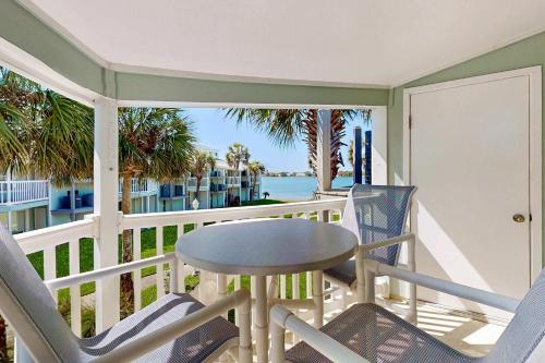 a balcony with a table and chairs and the ocean at Sand Dollar E201 in Pensacola Beach