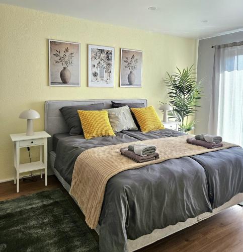 a bedroom with a bed with two towels on it at Luxus-Penthouse mit Panorama-View in Netphen