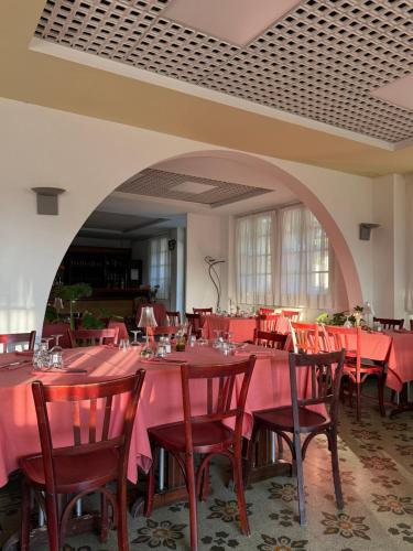 a dining room with red tables and chairs at La Châtaigneraie in Evisa