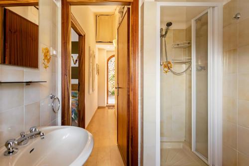 a bathroom with a white sink and a shower at Stanza con terrazzo vista lago LAKEHOLIDAY IT in Castel di Tora