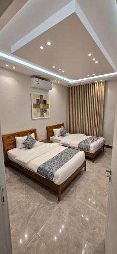 a bedroom with two beds in a room at قو اب إليت in Abā al Kibāsh