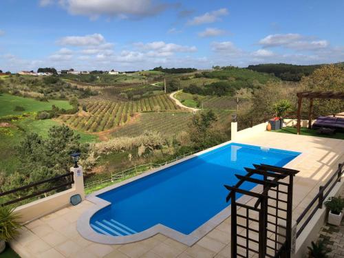 a swimming pool with a view of a vineyard at Terra Luso in Cadaval