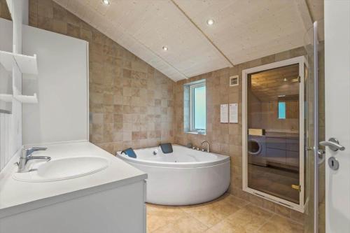 a bathroom with a tub and a sink and a shower at VE303-Oksbol-Kaervej-2 in Oksbøl