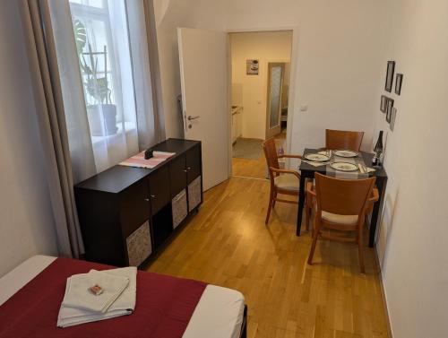 a room with a table and chairs and a bedroom at ANKU's in Krems an der Donau