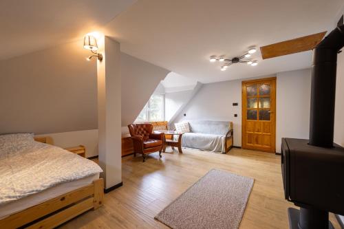 a bedroom with a bed and a table in a room at Domek nad rzeką in Joniec