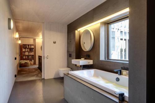 a bathroom with a tub and a sink and a window at 4 Bed in Ventnor oc-t32271 in Ventnor