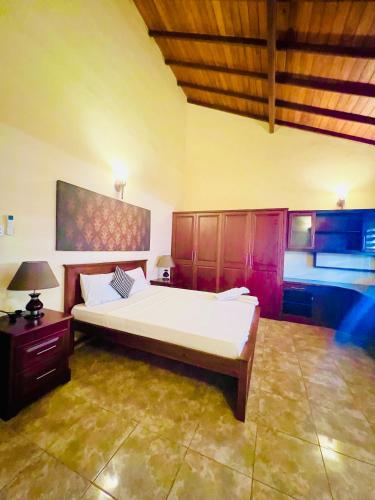 a large bedroom with a large bed in a room at Sunset Point Beachfront Villa & Restaurant in Negombo