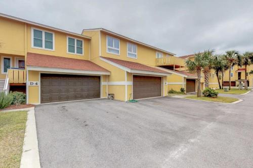 a large yellow house with two garage at Regency Cabanas #D4 in Pensacola Beach