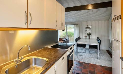 a kitchen with a sink and a counter top at VE465-Vejers-Strand-Violvej-1A in Vejers Strand