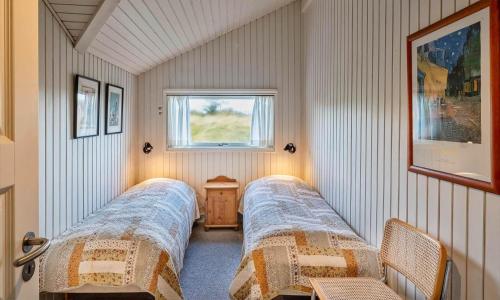 two beds in a small room with a window at VE465-Vejers-Strand-Violvej-1A in Vejers Strand