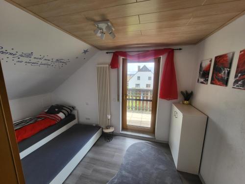 a small bedroom with a bed and a window at Große Ferienwohnung nähe dem schönen Seenland in Merkendorf
