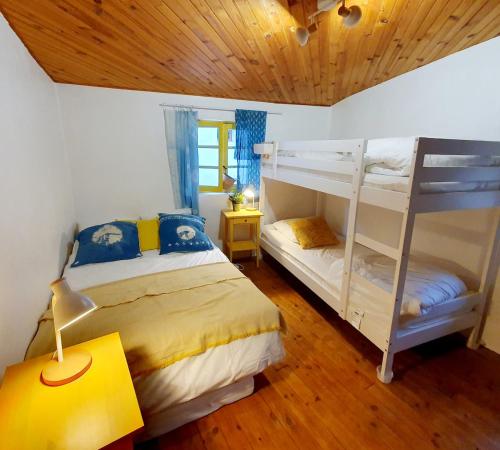 a bedroom with two bunk beds and a lamp at Gîte à Florac "Les Rêves Bleus" in La Salle-Prunet