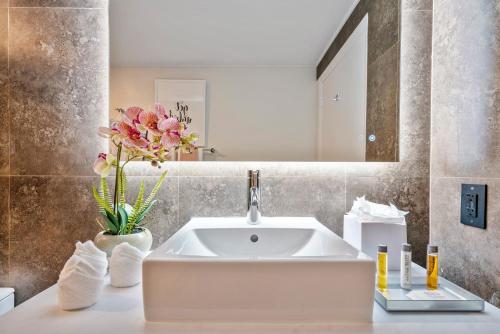a bathroom with a white sink and a mirror at Private Oasis at Arya in Miami
