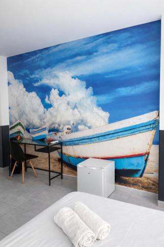 a painting of a boat on the beach at SolRoom (plz. La Nogalera) in Torremolinos