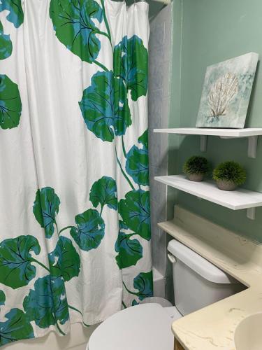 a bathroom with a shower curtain with a plant at BACK HOUSE in PASADENA in Pasadena