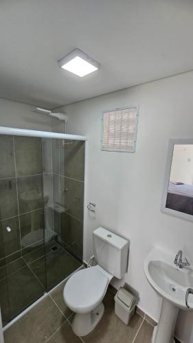 a bathroom with a toilet and a shower and a sink at Hotel In Box - Roseira in Roseira