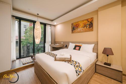 a bedroom with a large bed and a window at An Yên Island - Art Boutique Stay with Dual Lake view in Hanoi