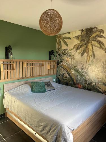 a bedroom with a large bed with a large mural at La Villa Carpentrassien in Carpentras