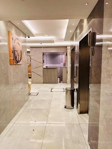 a large room with a lobby with a large floor at Melody Queen Hotel by AURA in Dubai