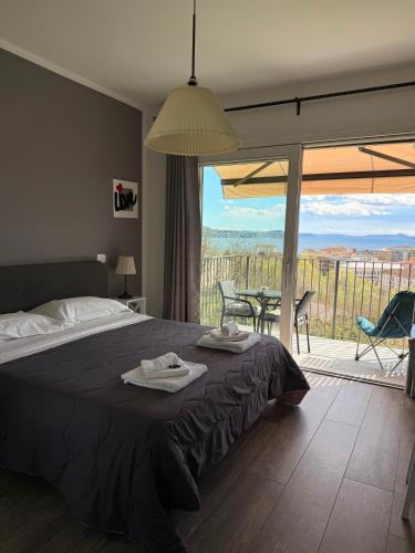 a bedroom with a bed and a balcony with a view at Stella Maggiore in Verbania