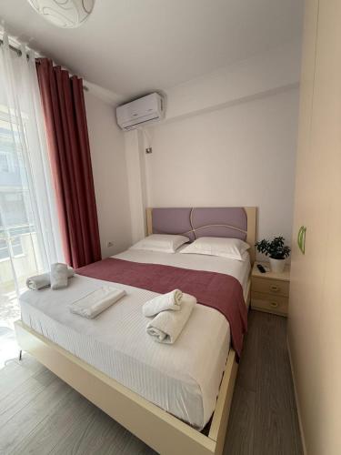a bedroom with two beds with towels on them at Luxury Room's by Lika in Sarandë
