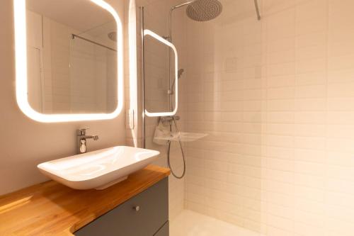 a bathroom with a sink and a shower at Face a la mer Cassis in Cassis