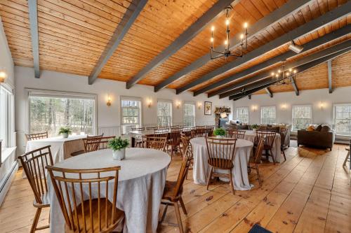 a banquet hall with tables and chairs in a room at Red Clover Inn in Mendon