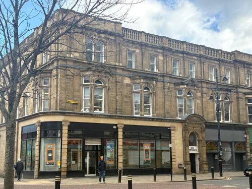 a man is standing in front of a building at The Athenaeum in Sunderland