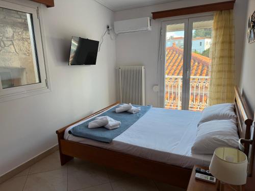 a bedroom with a bed with two towels on it at Leka Village Our Hidden Gem in Léka