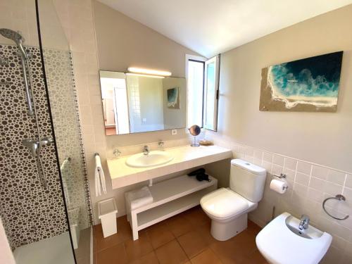 a bathroom with a sink and a toilet and a shower at Villa BEACH&OCEAN in Son Serra de Marina
