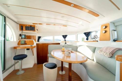 a kitchen and dining area of a boat with a table at Nuit en Catamaran aux Iles de Lérins in Cannes