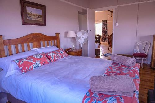 a bedroom with a large bed with two pillows at Karoo Secret Secret House in Aberdeen