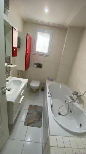 a bathroom with a tub and a sink and a toilet at SunWave Chott Meriem in Sousse