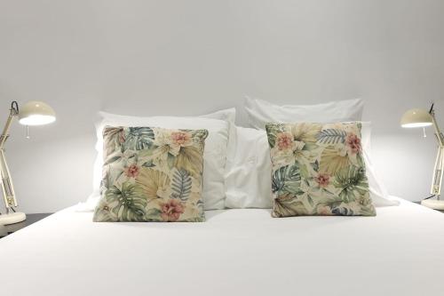 a white bed with two pillows on it at Bairro Alto Cozy apartment in Lisbon