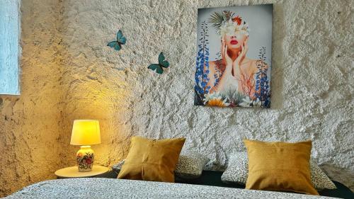 a bedroom with a bed with a painting on the wall at Nomads Village in Bled
