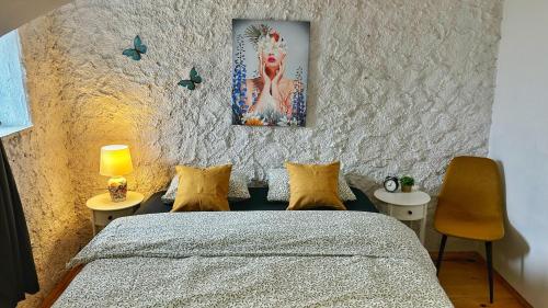 a bedroom with a bed and a painting on the wall at Nomads Village in Bled