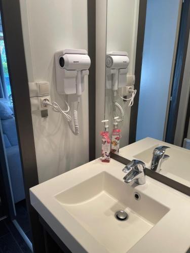 a bathroom with a sink and a hair dryer at Chalet Chez Nous Castellane in Castellane