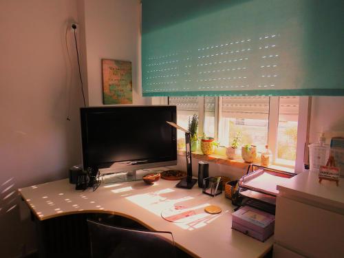 a desk with a computer monitor on top of it at Al-Madan in Almada