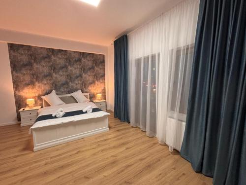 a bedroom with a bed and a large painting on the wall at Stadium Side Rooms in Craiova