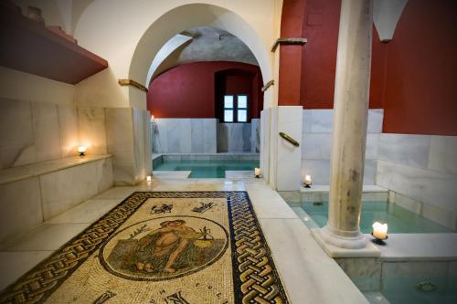 a bathroom with a mosaic floor in a building at Termas Aqua Libera in Aljucén