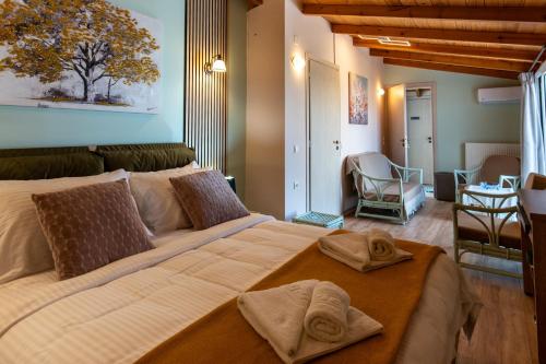 a bedroom with a large bed with towels on it at Maleme Maisonette in Maleme