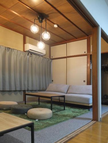 a living room with a couch and a table at Harbor Nook - Family Stay & Free 2 Car Parking in Takamatsu