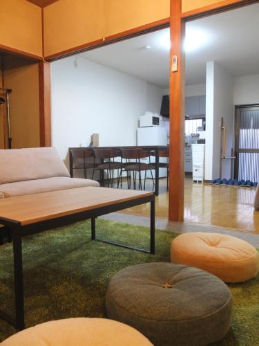 a living room with a couch and a table at Harbor Nook - Family Stay & Free 2 Car Parking in Takamatsu